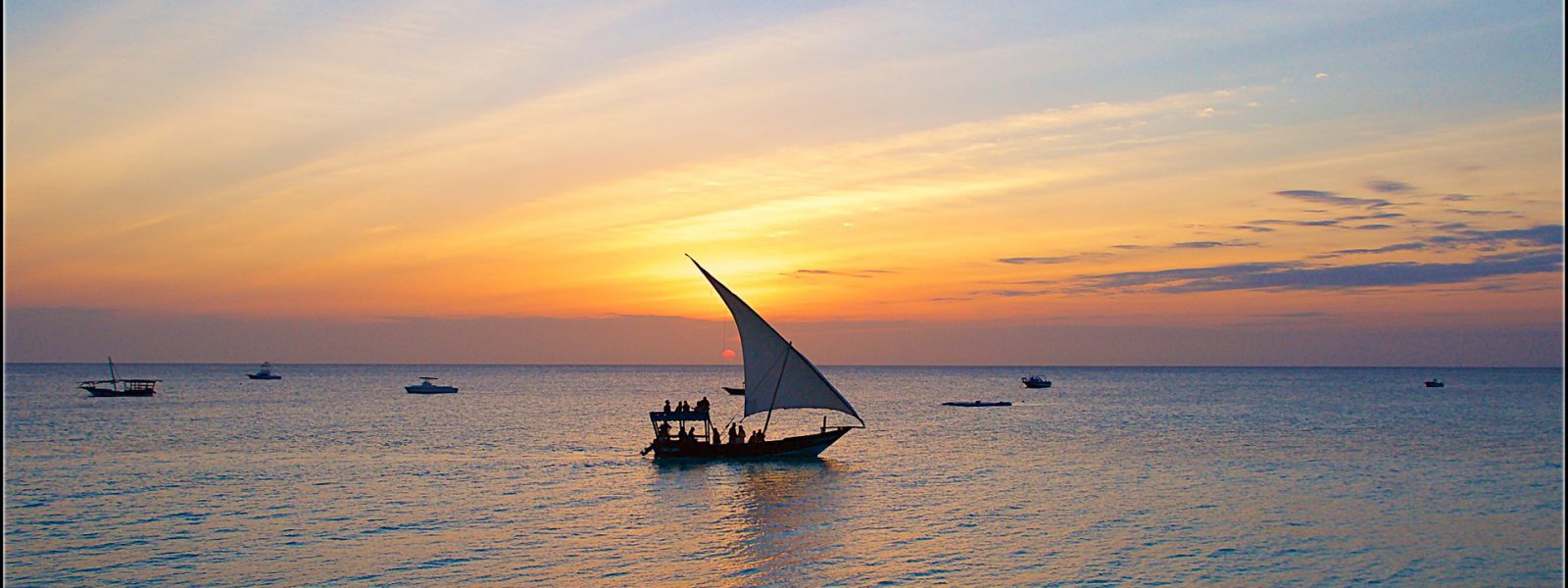 Dhow sailing at sunset on a Zanzibar day cruise