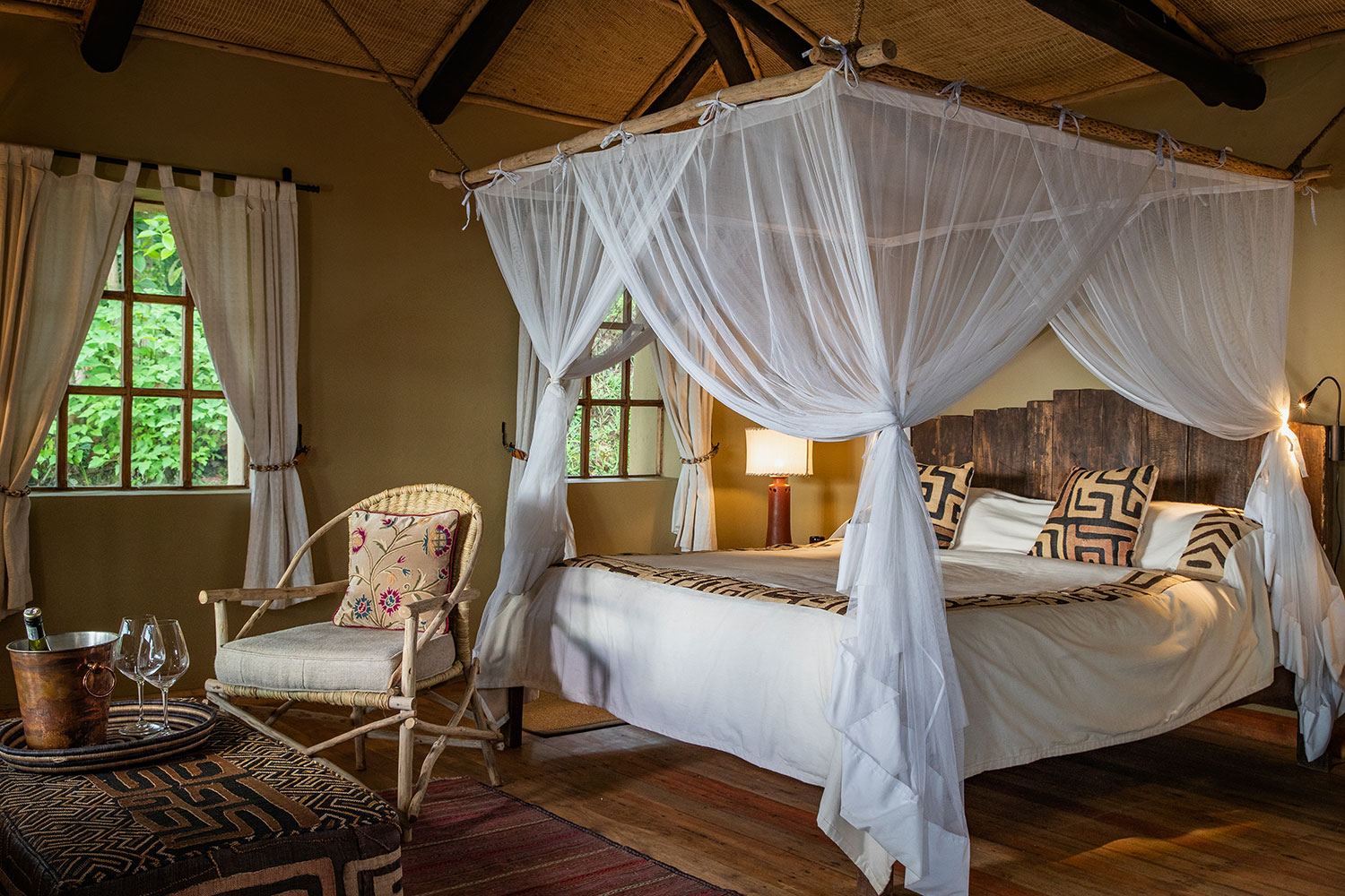 Four-poster bed with mosquito net in a luxury safari lodge